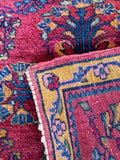 Handwoven 1920s Persian mini rug detailing plush wool pile texture and back weave.