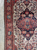 Handmade antique Persian rug with a floral design and mellowed vegetable dyed wool.
