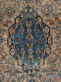 Close up of oversize Persian rug with traditional medallion layout and tribal artistry.