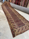 1920s antique Kurdish runner rug with midnight blue field and rust paisley motifs.