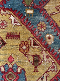 Collectible Persian folk art rug showcasing peacocks and stylized animal symbols on a golden field.