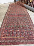 Antique Persian rug from the 1920s handwoven with vegetable dyed wool.
