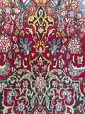 Fine weave antique rug showing subtle camel and soft pink accents woven into a traditional central medallion.