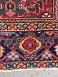 A durable and pet-friendly Persian Heriz wool rug built for high-traffic living showing a close up of the border band design.