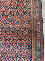 Large antique rug with navy field and beautifully balanced borders.