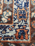 Close up view of border band tribal motifs in antique Persian rug. 