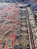 Antique Persian area rug with coral and blue vegetable dyed colors, late 19th century wool rug.