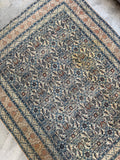Clean ready to use antique rug close up section highlighting minor vintage age wear and character stain in field.