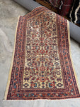 Antique Persian rug with ivory field and allover botanical design.