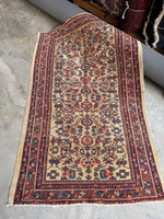Antique Persian rug with ivory field and allover botanical design.