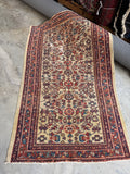 Antique Persian rug with ivory field and allover botanical design.