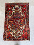 Low pile hand knotted antique Persian Ferahan rug with rare lavender and sky blue color palette.