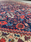 Vintage Persian rug featuring plum, teal, and hot coral accents.