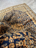  Antique Persian rug with a navy ground.