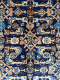 Detailed Herati field pattern on navy antique Persian rug with natural dyes.