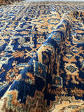 Natural dye color detail on antique Persian rug in navy, camel, and soft blue tones.