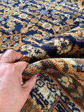 Texture close up showing plush lanolin rich wool pile on antique Persian rug.