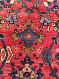 Antique Mahal rug featuring delicate blue and lavender flower motifs against a vibrant red ground.