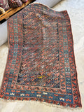 Antique Persian scatter rug with soulful worn finish, vegetable dyed wool, custom rug pad included, ideal for cottage, farmhouse, or English country homes.