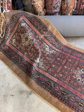 Skinny vintage Persian runner with intricate detailing.