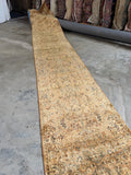2'8 x 20'8 golden long skinny hallway runner with scrolling vines and tightly woven Persian craftsmanship.