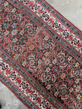 Antique Persian runner with small scale Herati pattern across espresso ground.