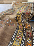 Long antique tribal runner with camel field, earthy tones, and low wool pile.