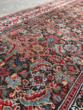 Espresso ground Persian runner with blues camel yellow pink and coral accents.