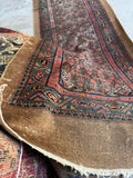 Low pile antique Persian runner with scattered wear.