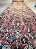 Antique Persian runner featuring allover floral design and dainty borders.
