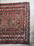 Aged Persian runner with small scale geometric floral Herati field.