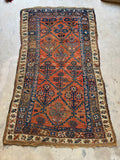 Antique Persian runner with vegetable dyed wool and angular diamond lattice filled with blooming floral motifs.
