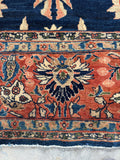 Border detail of Persian Sarouk rug with warm terracotta tones.