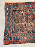 Distressed Persian scatter rug with coral, navy, dusty blue, and camel vegetable dyes, handmade antique rug full of history and character.