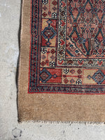 Corner view of long narrow Persian Seraband runner handwoven with vegetable dyed wool.
