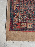 Corner view of long narrow Persian Seraband runner handwoven with vegetable dyed wool.