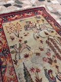 Green sage background Persian rug close-up shot highlighting the soft, faded background color and fine hand-knotted pile.