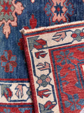 Underside view of a vintage Caucasian prayer rug displaying vegetable dyed wool and weave texture. 