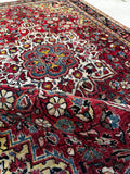 Close up view of antique Persian rug with authentic age wear and stout texture of hand-spun wool.
