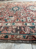 Hand knotted Persian Gharajeh rug with tribal symmetry and soft aged terracotta and walnut tones.
