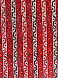 Close up view of 1920s red geometric Persian accent rug crafted with natural vegetable-dyed wool.