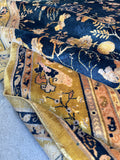 Hand knotted antique Indian rug with soft sheen and floral elements.