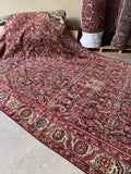 Top-down view of antique Caucasus rug layout