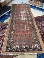 Full view of antique Persian runner with a camel border band and some scattered wear.