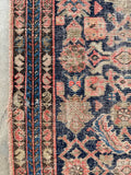 Paisley motif border bands in alternating colors on worn Persian runner.