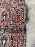 Skinny antique runner showcasing intricate Persian floral patterns and border bands.