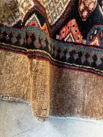 Antique Persian rug with security fence border motifs.