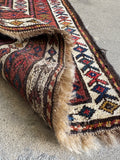 Detail of hand knotted wool pile on Kurdish Persian runner.