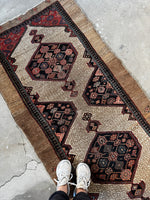 Long Persian runner with decorative spandrels.