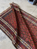 Antique Kurdish rug showing main field flame boteh design and floral border bands.